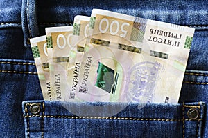 Ukrainian money. New banknotes five hundred hryvnia bills UAH in the back pocket of blue jeans. Money concept