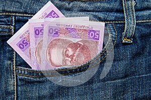 Ukrainian money in a pocket of blue jeans