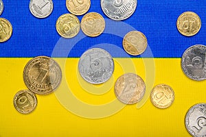 Ukrainian national coins against the background of the national yellow-blue flag. Eurovision currency