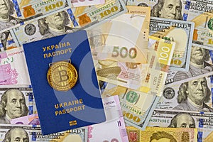 Ukrainian passport with money dollars and hryvnia, close-up top view concept finance