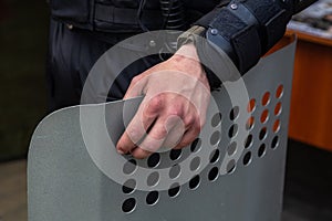 Ukrainian police officer with a metal shield at the protest