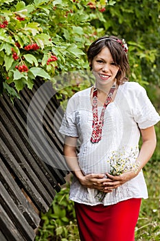 Ukrainian pregnant woman in traditional embroidered shirt