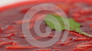 Ukrainian and russian national food - red beet soup borscht with beef.Moldovan soup. Close up. plate of beetroot cream