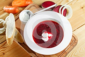 Ukrainian and russian red-beet soup borscht with garlic and sour cream