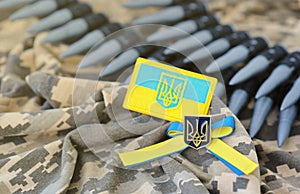 Ukrainian symbol and a machine gun belt on the camouflage uniform of a Ukrainian soldier. The Concept of war in Ukraine