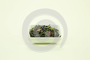 Ukrainian tea. Tea Emperor`s Choice. Green tea with cornflowers, rose petals and marigold flowers. Isolated in a white bowl on a