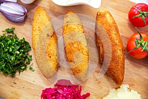 Ukrainian tradition food on a wooden board . Red cabbage sauerkraut in a small bowl . mashed potatoes . Mayonnaise, Garlic, Onion