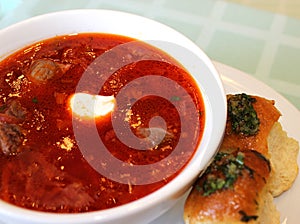 Ukrainian traditional dinner. borscht with meat and garlic pampushkami.