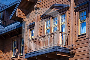 Ukrainian traditional rural wooden house, background exterior facade with windows frame and balcony. Kyiv, Ukraine