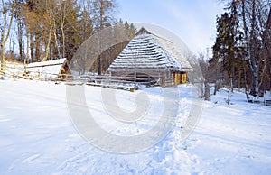 Ukrainian village cultural heritage historic house cabin in the woods of winter snowy beautiful day time scenery natural