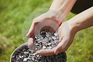 Ukrainian volunteer holding homemade shrapnel to make bombs