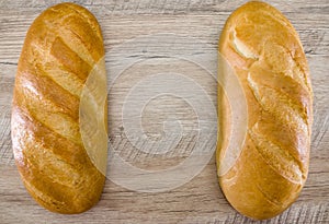 Ukrainian white bread on a wooden background. Place for text. Copy space. View from above.Two loaves