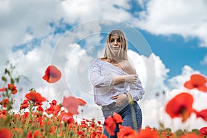 ukrainian young lady in white blouse in the field of poppies