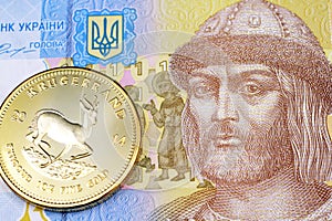 A Ukranian one hryvnia bank note with a gold Krugerrand