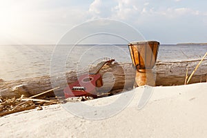 Ukulele and ethnic drum on a sunny beach.