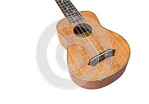 Ukulele Hawaii guitar on white background, mage from Okoume wood, Selective focus