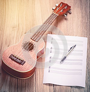 Ukulele and musical paper notes