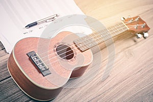 Ukulele and musical paper notes