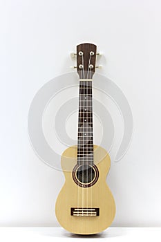 ukulele with white wall background