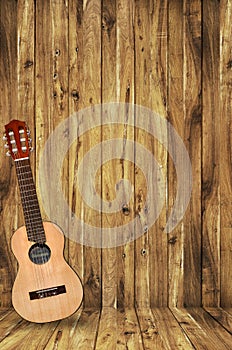 Ukulele on wood background