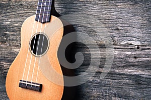 Ukulele with wooden background. Acoustic music instrument. Art a