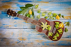 Ukulele with Ylang-ylang flower and leaf