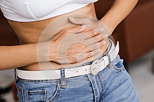 Ulcer or gastritis stomach ache. Sick african american girl hold abdomen because it hurts. Pancreatitis disease of