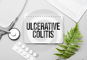 Ulcerative Colitis word on notebook,stethoscope and green plant photo