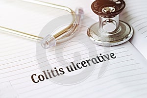 Ulcerative colitis written in an open notebook with stethoscope photo