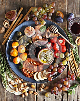 The Ultimate Appetizer Platter. Charcuterie Board with various of cured meat, chees, nuts and fruits.