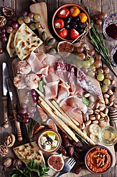 The Ultimate Appetizer Platter. Charcuterie Board with various of cured meat, chees, nuts and fruits.