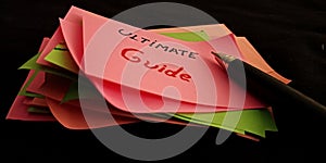 ultimate guide displayed with pen pointer on black background