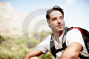 The ultimate outdoorsman. Thoughtful hiker enjoying a mountain top view.