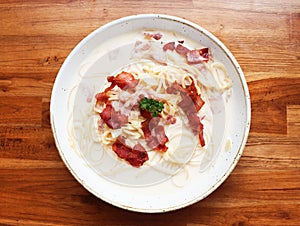 Ultimate Pasta  spaghetti carbonara recipe is Traditional Italian food  sprinkle on top with bacon  and Fresh Parsley in a cream