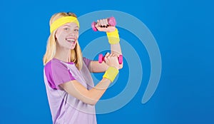 Ultimate upper body workout for women. Fitness instructor hold little dumbbell blue background. Fitness concept. Girl