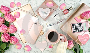 Ultra feminine pink desk workspace with rose gold accessories flatlay.