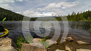 Ultra high definition 4k time lapse movie of moving clouds and people kayaking and boating in Trillium Lake Clackamas County