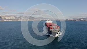 Ultra large loaded container ship cruising in open ocean, aerial view