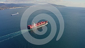 Ultra large loaded container ship cruising in open ocean, aerial view