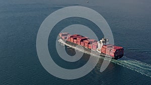 Ultra large loaded container ship cruising in open ocean, aerial view