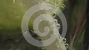 Ultra macro ECU bubbles gathered on a white straw in a glass of cool fizzy tonic