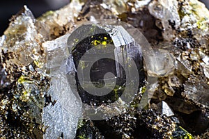 Ultra macro focused picture of small clear quartz cluster points with dark green epidote