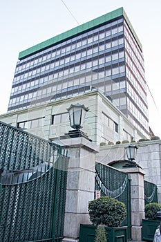 Ultra modern beautiful gray building with sculptured gates, and lamp lights