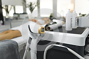 ultra-modern laser depilation apparatus for hair removal at the salon, beauty treatment concept woman lying on a table