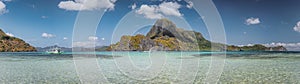 Ultra wide banner of El Nido bay with trip boat and Cadlao island, Palawan, Philippines. Panoramic view