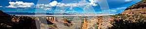 Ultra-wide panoramic view looking east toward Grand Junction from Colorado National Monument