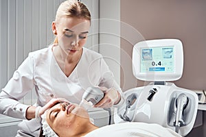 Ultraformer lifting. Face Skin Care. Close-up Of Woman Getting Facial Hydro Microdermabrasion Peeling Treatment At