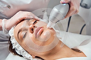 Ultraformer lifting. Face Skin Care. Close-up Of Woman Getting Facial Hydro Microdermabrasion Peeling Treatment At