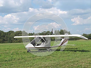 Ultralight aircraft in grassy field