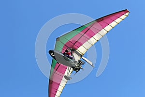 Ultralight airplane flying in a blue sky